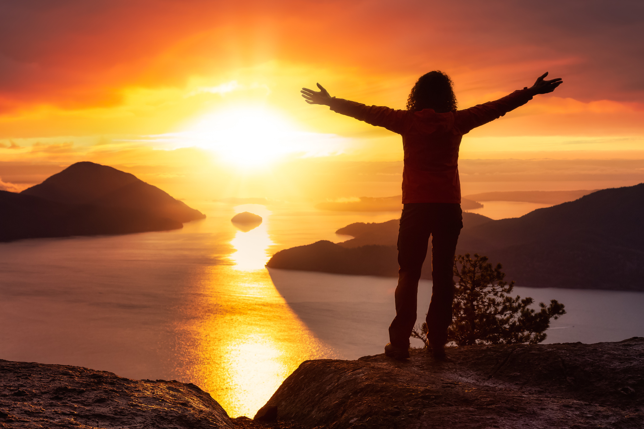 Adventurous Person on Top of a Mountain